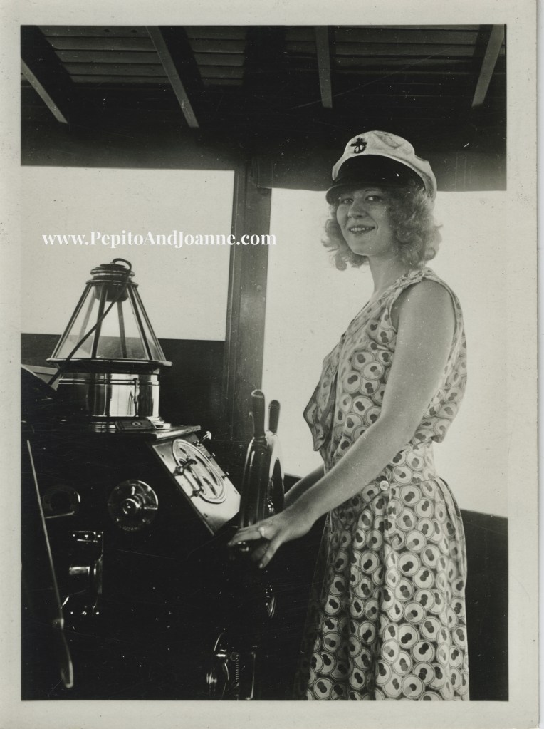 Caption:  Joanne Perez piloting "The Phantom," their Matthews 38’ sport cruiser, circa 1931